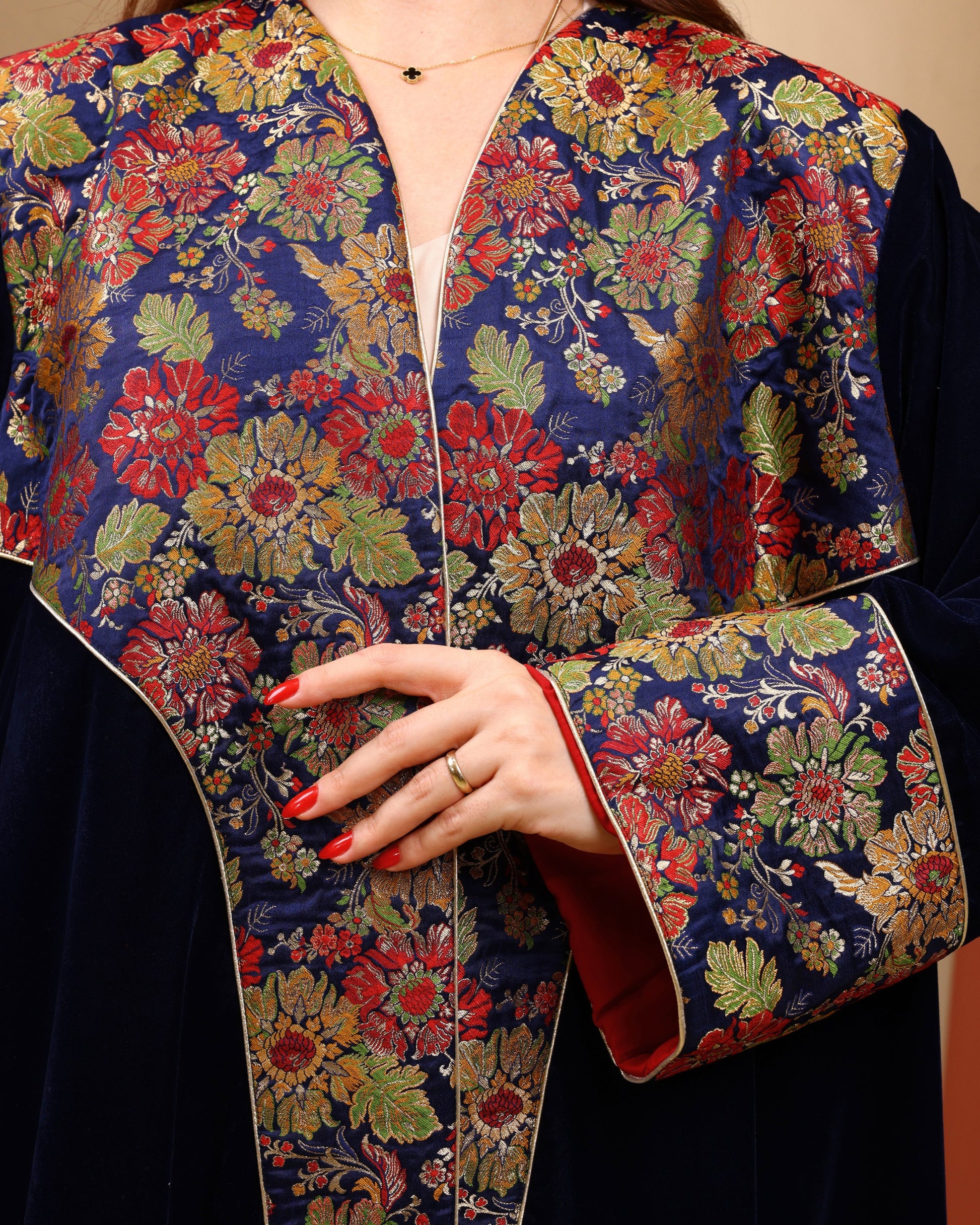 Floral embroidered brocade jacket with a person wearing it, focusing on the intricate design.